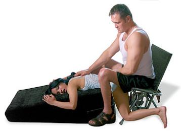 A clothed couple demonstrates a comfortable position with the IntimateRider Adventure Set.